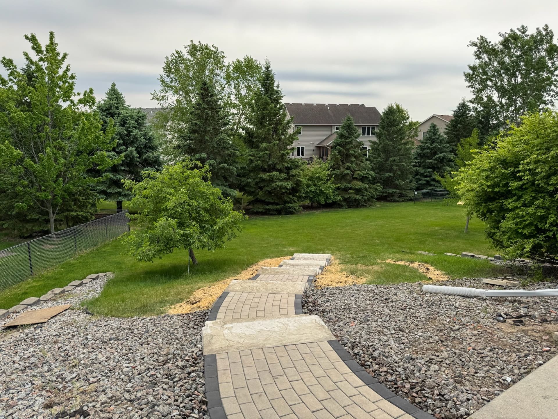 Paver Pathway and Staircase Built Down a Sloped Backyard