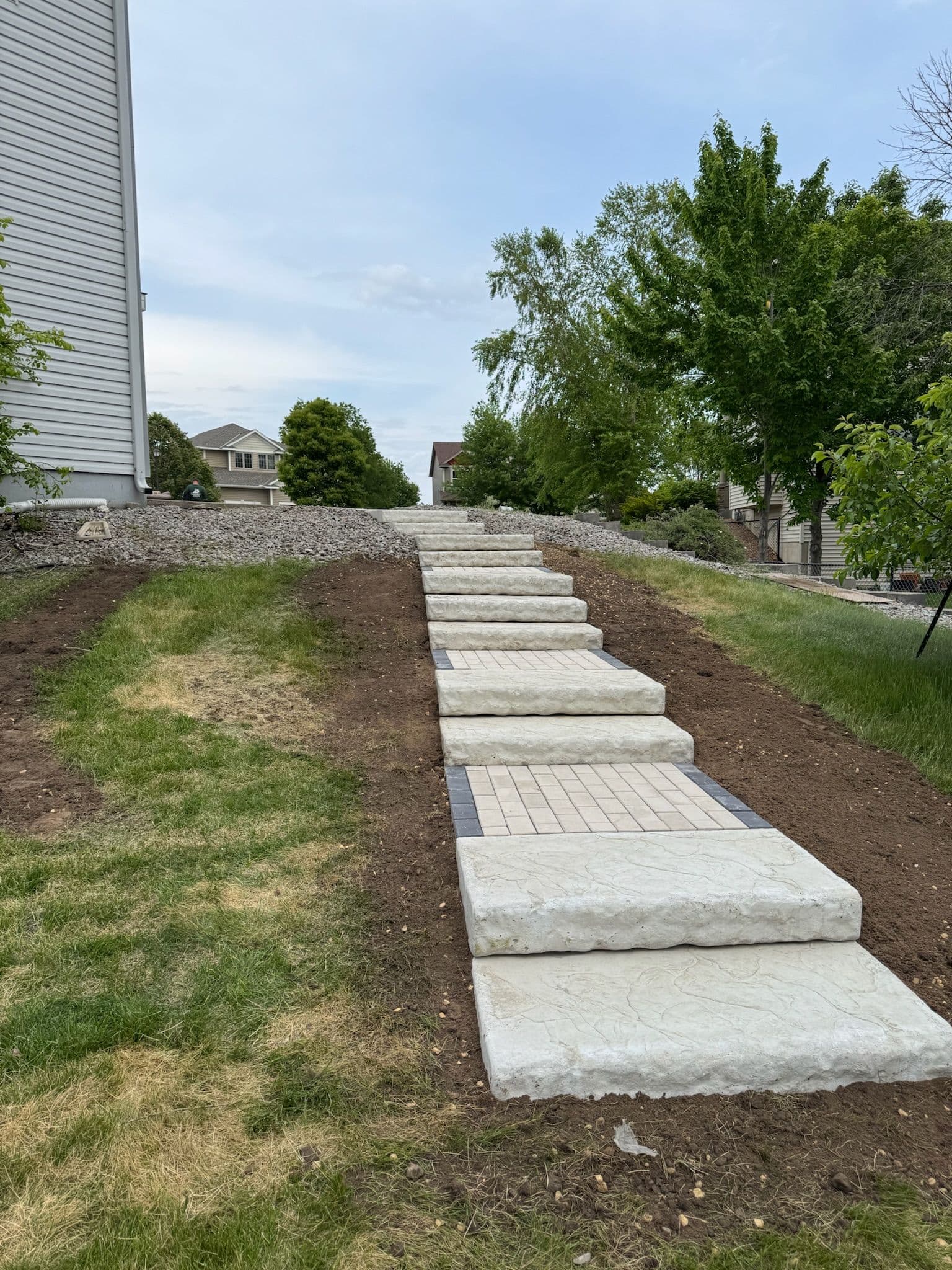 Paver Pathway and Staircase Built Down a Sloped Backyard